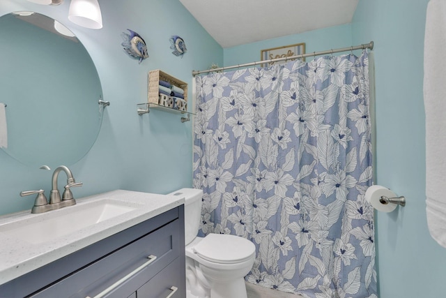 bathroom featuring vanity, a shower with shower curtain, and toilet