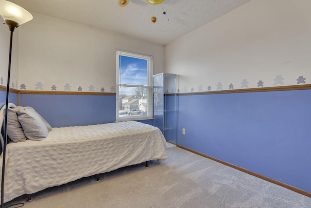 carpeted bedroom featuring ceiling fan, baseboards, and lofted ceiling