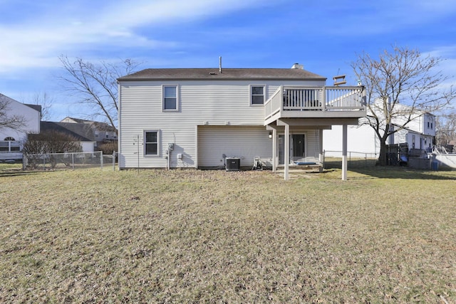 rear view of property with a gate, a yard, a fenced backyard, and central AC