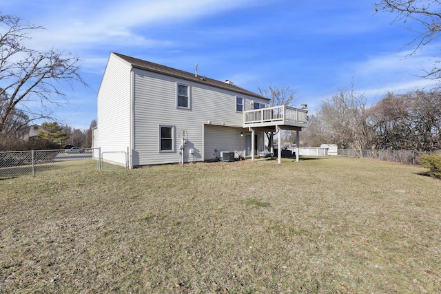 rear view of house featuring a deck, a yard, a fenced backyard, and central AC