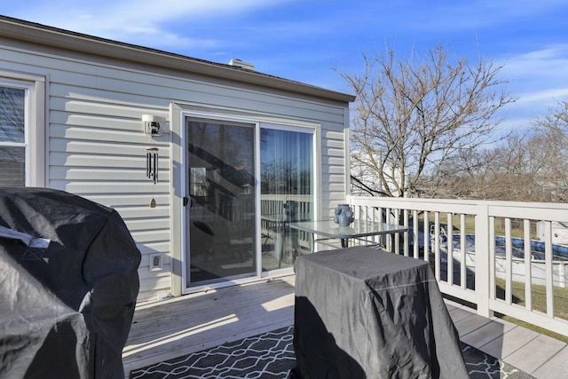 wooden deck featuring a grill