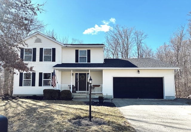 traditional-style house with a porch, driveway, and a garage