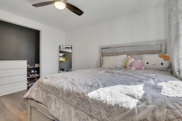 bedroom featuring wood finished floors and a ceiling fan