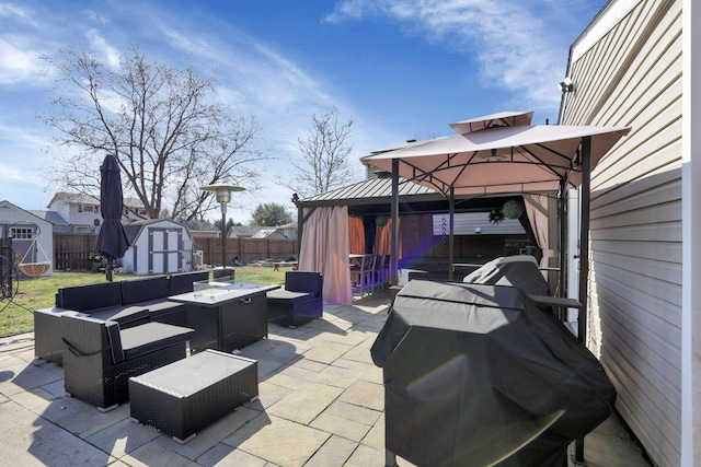 view of patio / terrace with an outbuilding, a fenced backyard, a shed, a gazebo, and outdoor lounge area