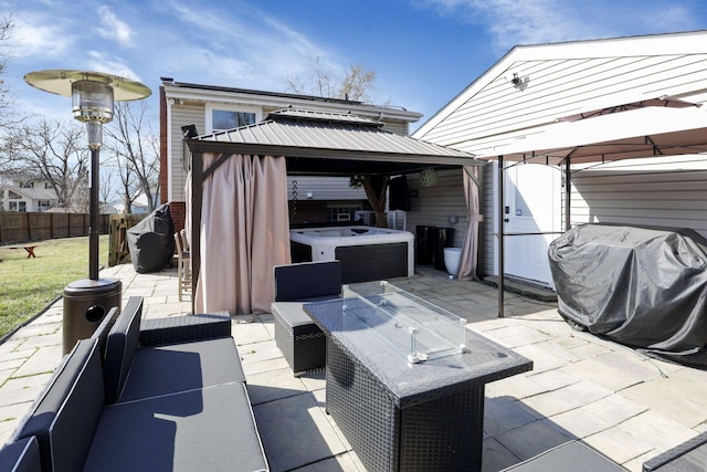 view of patio / terrace featuring a gazebo, grilling area, a hot tub, and fence