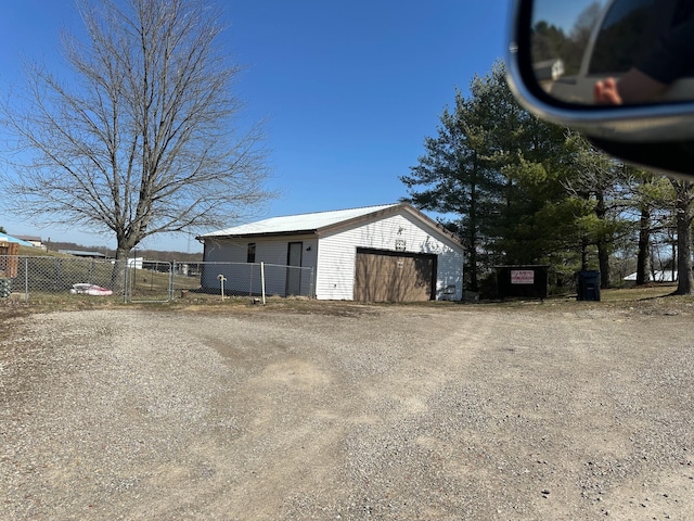 detached garage featuring fence