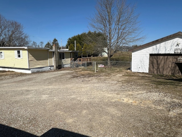 view of yard with a detached garage and fence