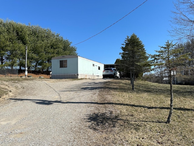 view of side of home featuring driveway