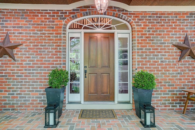 view of exterior entry with brick siding