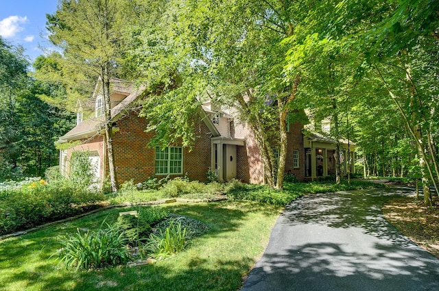 view of front facade featuring a garage and brick siding