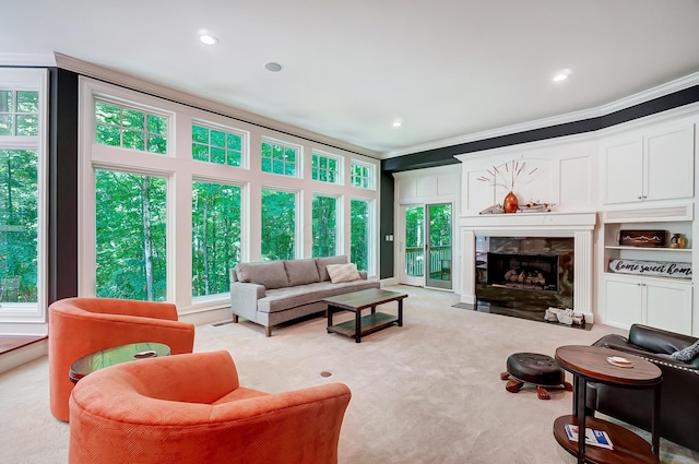 carpeted living area with recessed lighting, a fireplace, and ornamental molding