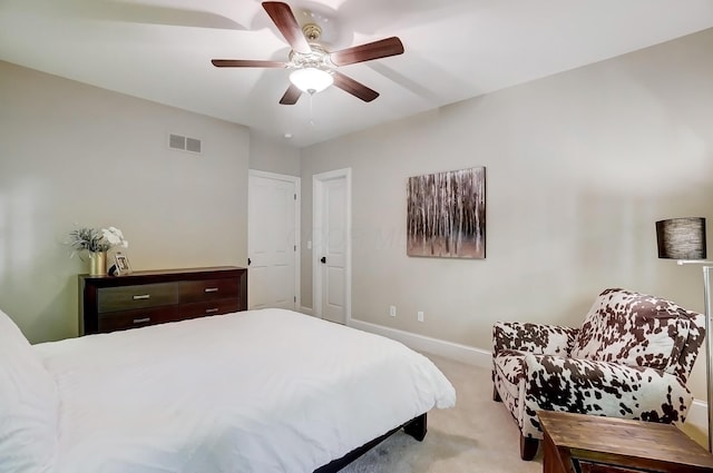 bedroom featuring light carpet, visible vents, a ceiling fan, and baseboards