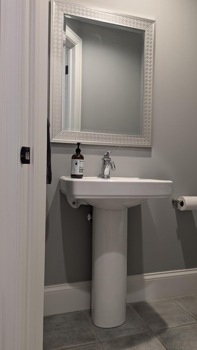 bathroom with tile patterned floors and baseboards