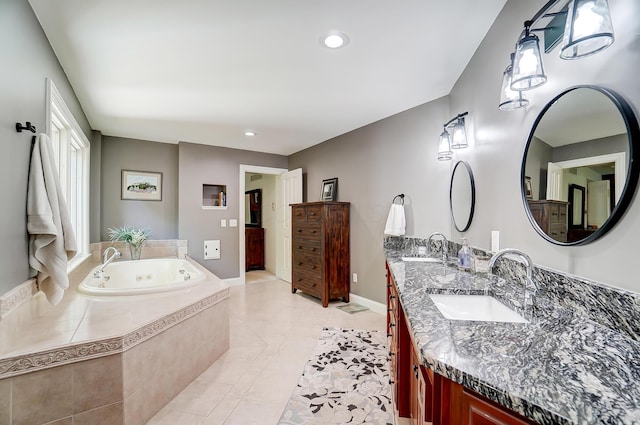 bathroom featuring tile patterned floors, a whirlpool tub, double vanity, and a sink