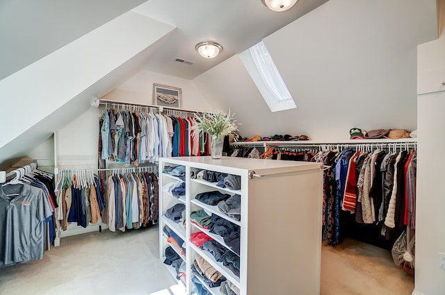 walk in closet featuring light carpet, visible vents, and lofted ceiling with skylight