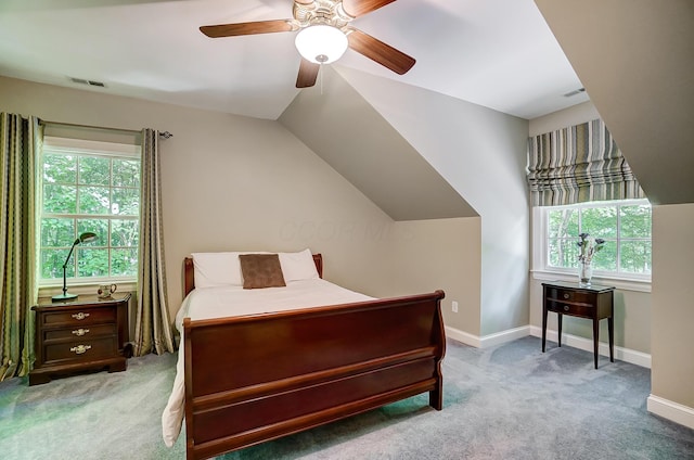 bedroom with light carpet, visible vents, and multiple windows