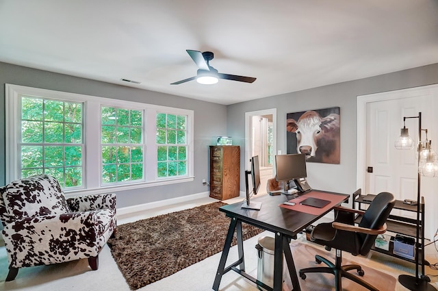 office space with visible vents, baseboards, and a ceiling fan