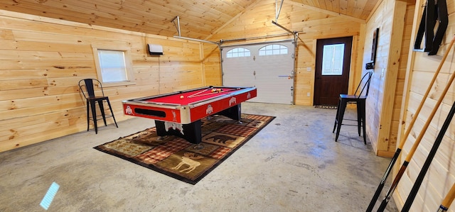 game room featuring billiards, concrete floors, wood walls, a garage, and vaulted ceiling