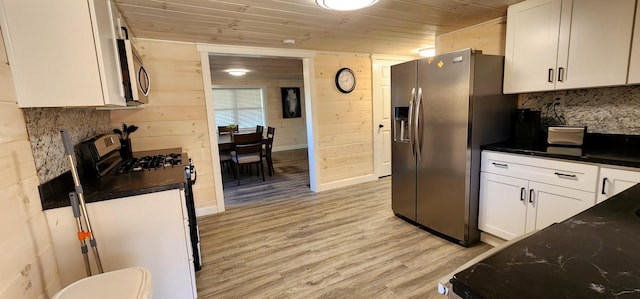 kitchen featuring white cabinets, appliances with stainless steel finishes, wooden ceiling, and light wood-style floors