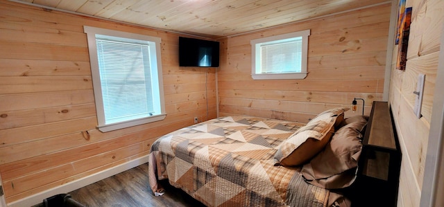 bedroom featuring multiple windows, wood finished floors, wood walls, and wooden ceiling