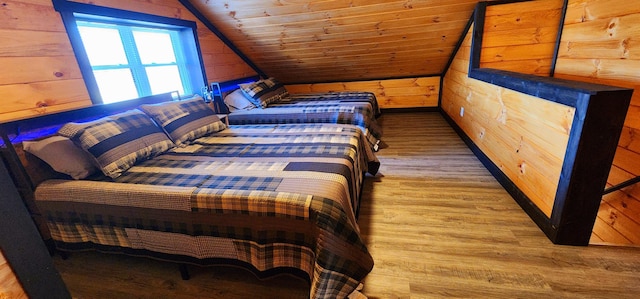 bedroom with wooden walls, wood finished floors, wooden ceiling, and vaulted ceiling