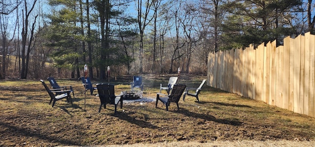 view of yard with a fire pit and fence