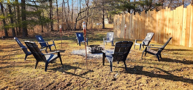 exterior space featuring a fire pit and fence