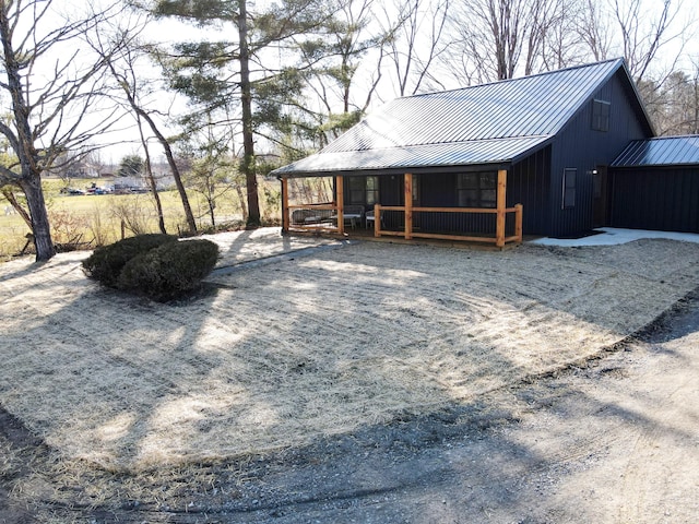 exterior space with covered porch and metal roof