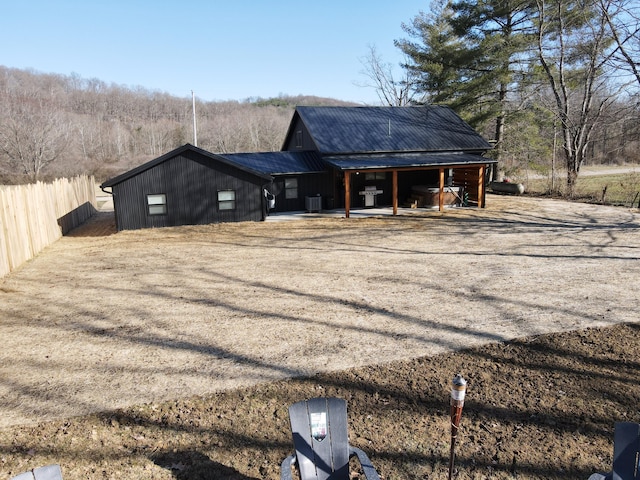 exterior space with metal roof and fence