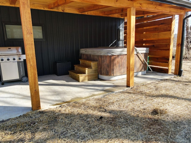 view of patio / terrace with grilling area and a hot tub