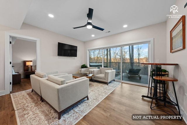 living room featuring a ceiling fan, recessed lighting, wood finished floors, and visible vents