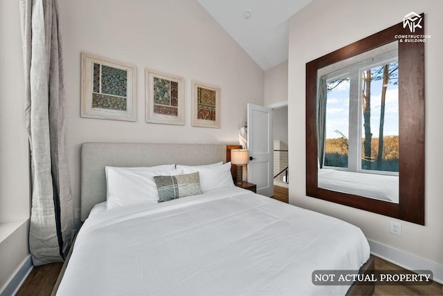 bedroom featuring dark wood-style flooring, baseboards, and vaulted ceiling