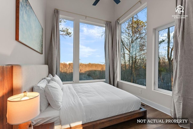 bedroom with baseboards and wood finished floors