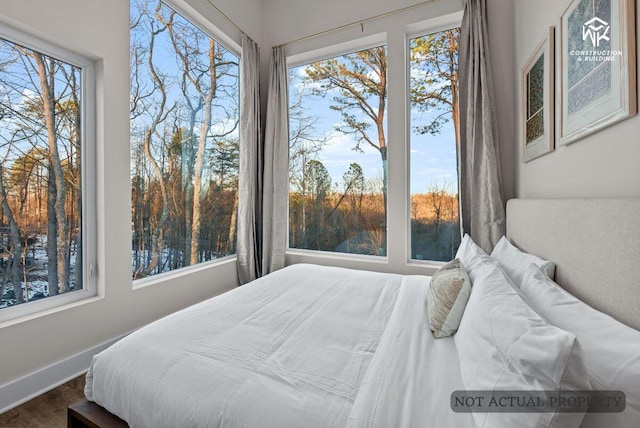 bedroom featuring baseboards and wood finished floors