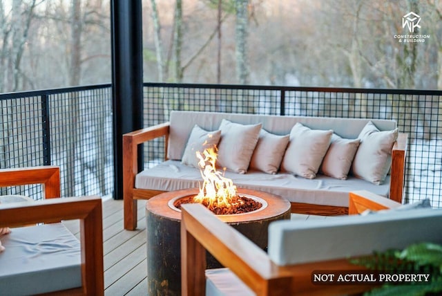 balcony with an outdoor living space with a fire pit