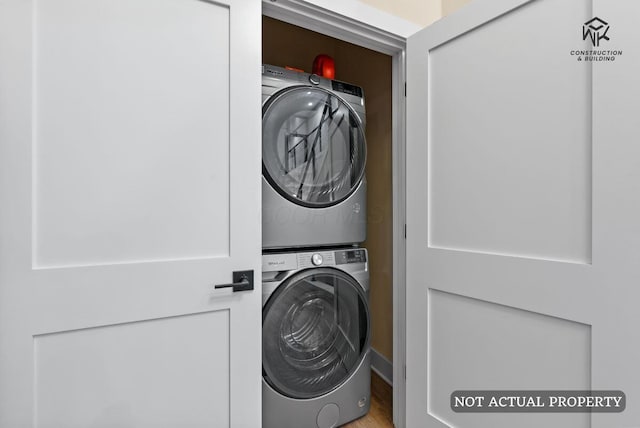 washroom featuring laundry area and stacked washer and clothes dryer