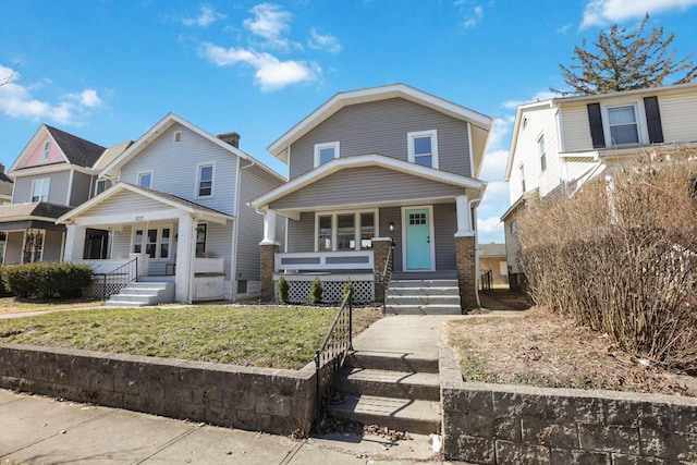 view of front of house with a porch and a front lawn