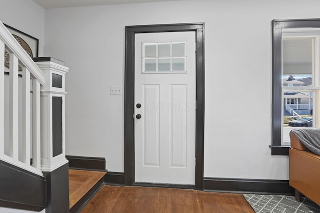 entrance foyer featuring baseboards and wood finished floors