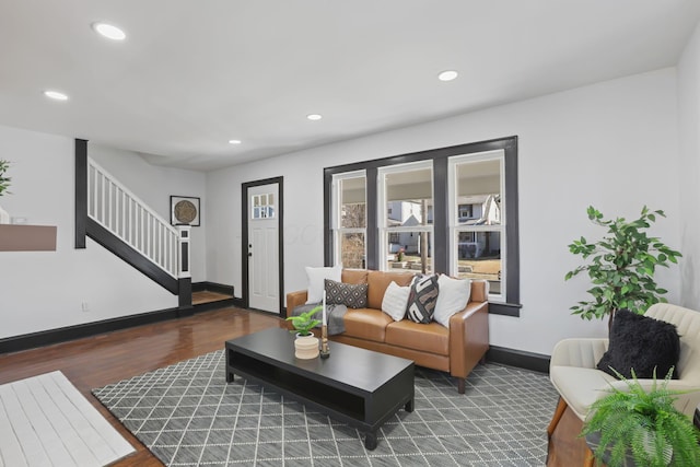 living room with stairs, recessed lighting, wood finished floors, and baseboards