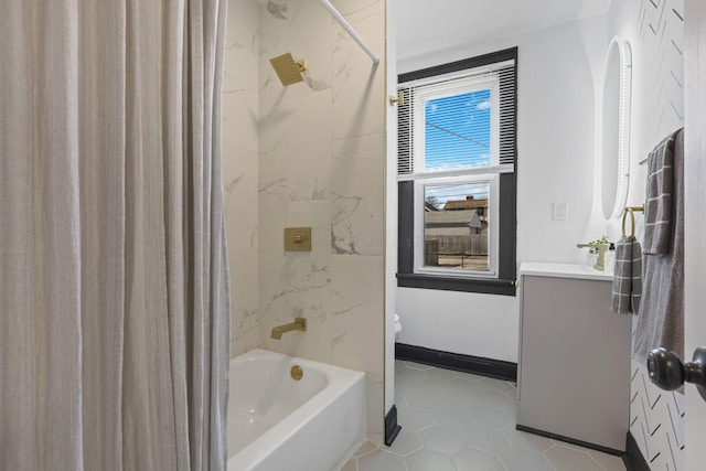 full bath featuring vanity, shower / bathtub combination with curtain, baseboards, tile patterned flooring, and toilet