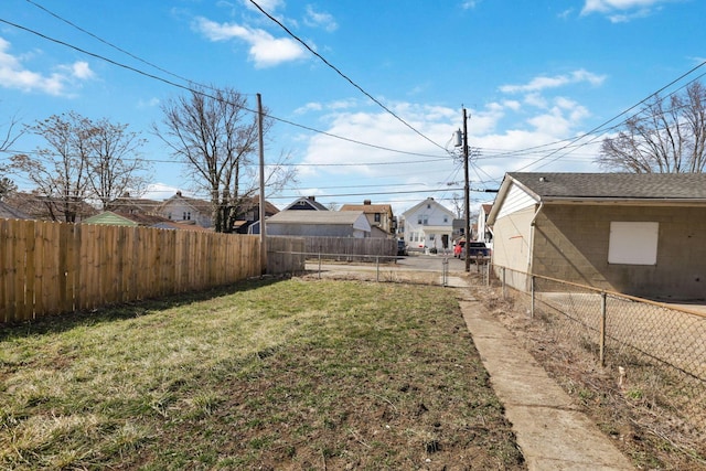 view of yard featuring a residential view and a fenced backyard