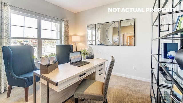 carpeted office space featuring baseboards