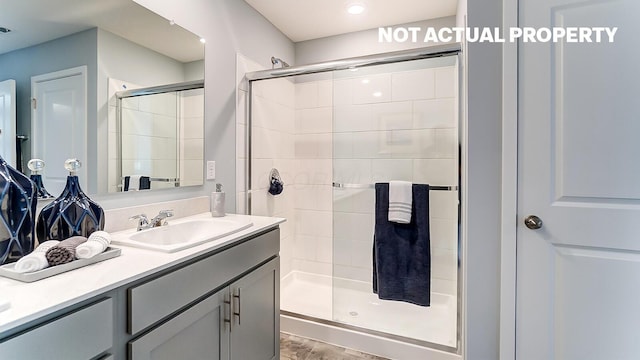 bathroom featuring vanity and a shower stall