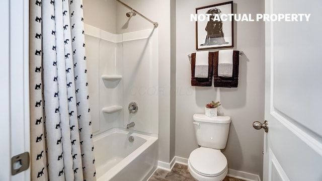 full bathroom with shower / bath combination with curtain, toilet, and baseboards