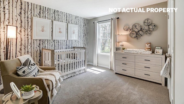 carpeted bedroom with baseboards, a crib, and wallpapered walls