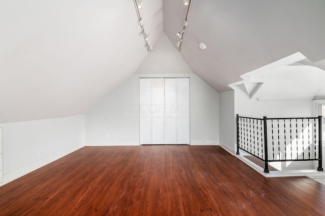 bonus room featuring lofted ceiling, baseboards, and wood finished floors