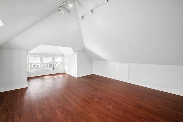 additional living space with lofted ceiling, baseboards, and wood finished floors