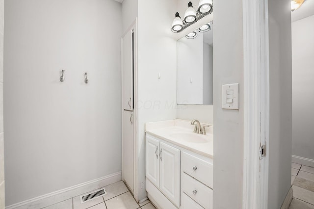 bathroom featuring tile patterned flooring, vanity, visible vents, and baseboards