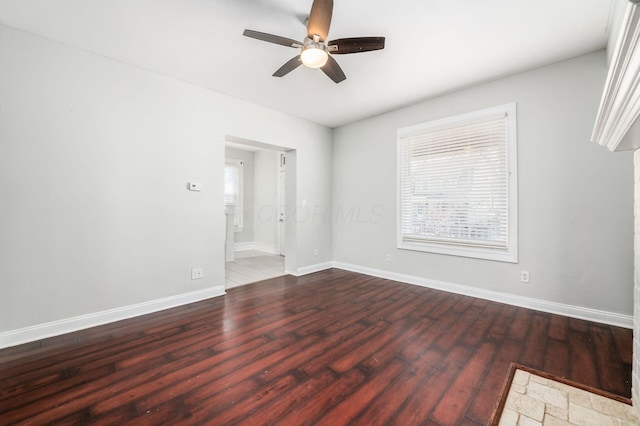 unfurnished room with ceiling fan, baseboards, and wood finished floors