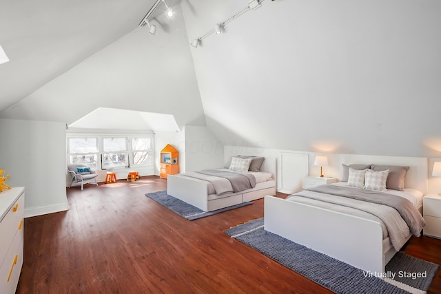 bedroom featuring vaulted ceiling, baseboards, and wood finished floors